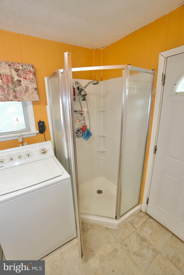 4425 E Howell St, Philadelphia, PA 19135 - full bath featuring washer / dryer, a shower stall, and tile patterned floors