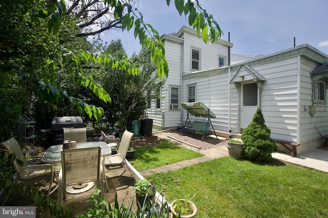 4425 E Howell St, Philadelphia, PA 19135 - rear view of property with a patio area, a lawn, and outdoor dining area