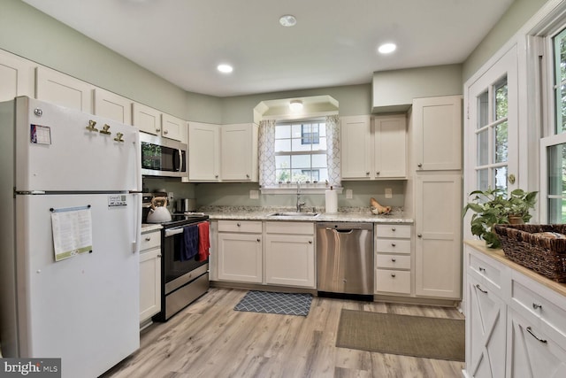 4408 Saul Rd, Kensington, MD 20895 - kitchen featuring stainless steel appliances, healthy amount of natural light, white cabinetry, light wood-style flooring, and recessed lighting