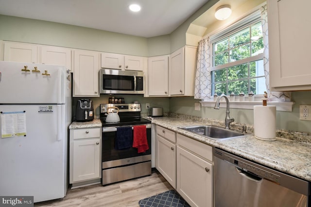 4408 Saul Rd, Kensington, MD 20895 - kitchen with appliances with stainless steel finishes, light countertops, white cabinetry, light wood-style floors, and recessed lighting