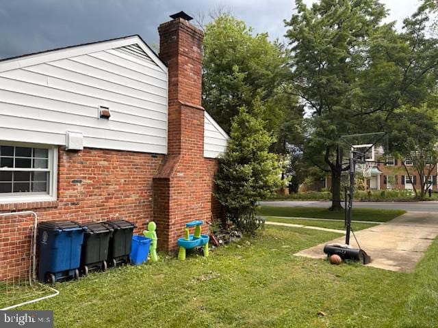4408 Saul Rd, Kensington, MD 20895 - view of side of property with a chimney, a lawn, and brick siding