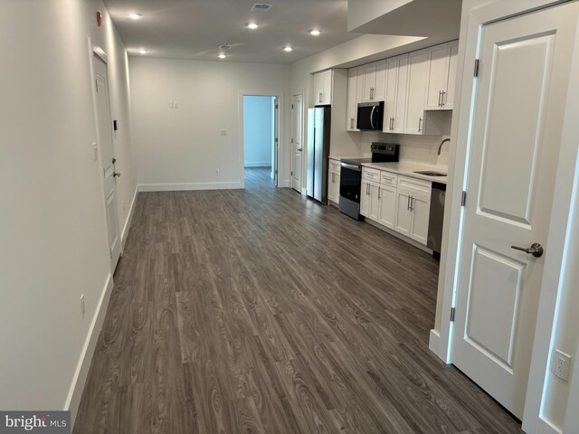 2209 N 7th St, Philadelphia, PA 19133 - kitchen featuring appliances with stainless steel finishes, dark wood-style floors, white cabinetry, light countertops, and recessed lighting