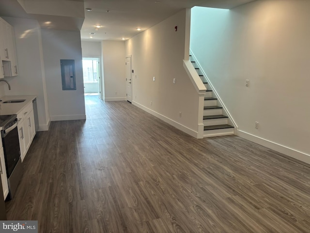 2209 N 7th St, Philadelphia, PA 19133 - unfurnished living room featuring electric panel, dark wood finished floors, and stairs