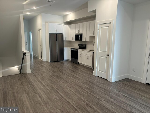 2209 N 7th St, Philadelphia, PA 19133 - kitchen featuring stainless steel appliances, dark wood-style floors, white cabinetry, light countertops, and recessed lighting