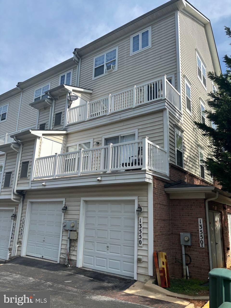 13552 Station St Unit 13552, Germantown, MD 20874 - rear view of property with a garage, asphalt driveway, and brick siding