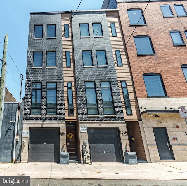 1217 Bainbridge St, Philadelphia, PA 19147 - view of property with driveway and an attached garage