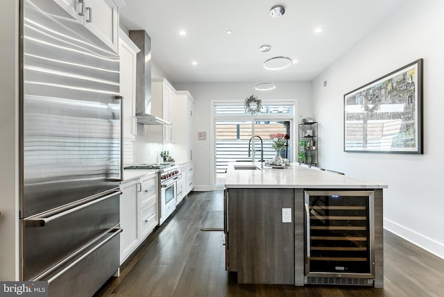 1217 Bainbridge St, Philadelphia, PA 19147 - kitchen with high end appliances, wine cooler, wall chimney range hood, dark wood finished floors, and recessed lighting