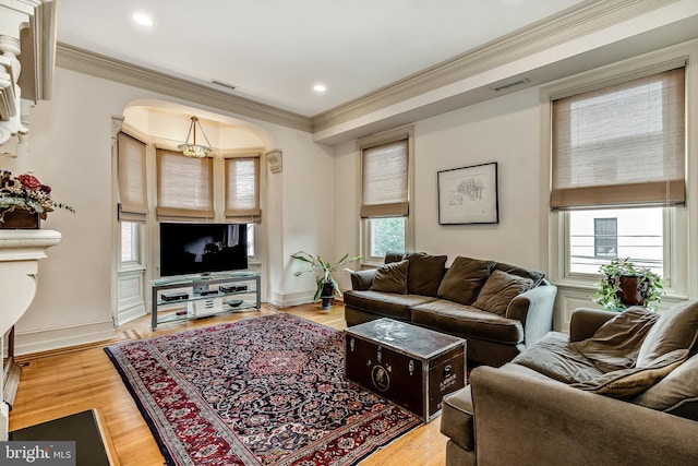 2101 Wallace St, Philadelphia, PA 19130 - living area featuring arched walkways, crown molding, wood finished floors, and recessed lighting