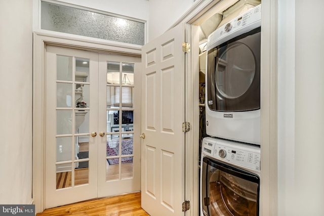 2101 Wallace St, Philadelphia, PA 19130 - laundry room featuring stacked washer and clothes dryer, french doors, and light wood-style flooring