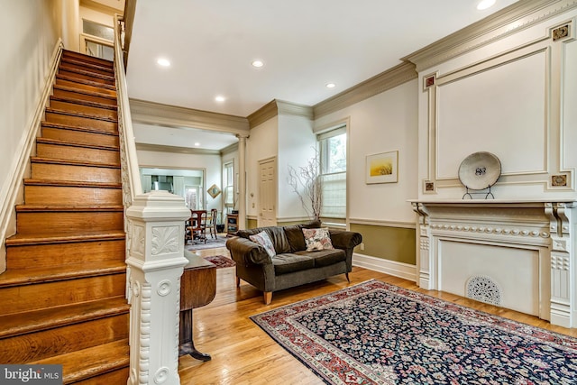 2101 Wallace St, Philadelphia, PA 19130 - living room with stairs, ornamental molding, light wood-style floors, and recessed lighting