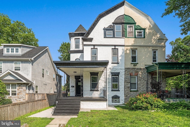 13 W Upsal St, Philadelphia, PA 19119 - view of front of home featuring covered porch, stucco siding, and stone siding