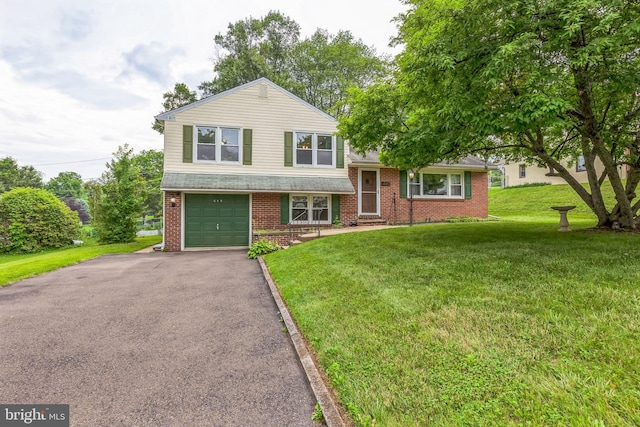680 Davisville Rd, Warminster, PA 18974 - split level home with an attached garage, brick siding, driveway, and a front yard