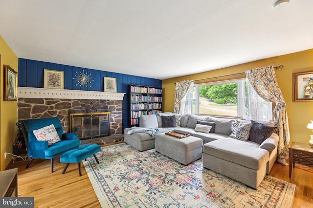680 Davisville Rd, Warminster, PA 18974 - living room with wood finished floors, a stone fireplace, and an accent wall