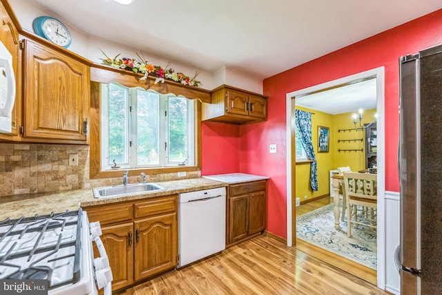 680 Davisville Rd, Warminster, PA 18974 - kitchen featuring white appliances, light wood-style flooring, light countertops, and brown cabinetry