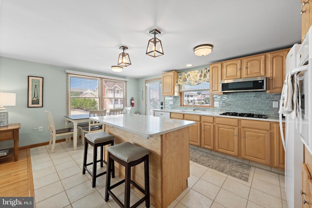 6203 Long Beach Blvd, Long Beach Township, NJ 08008 - kitchen featuring white appliances, light countertops, backsplash, a center island, and plenty of natural light