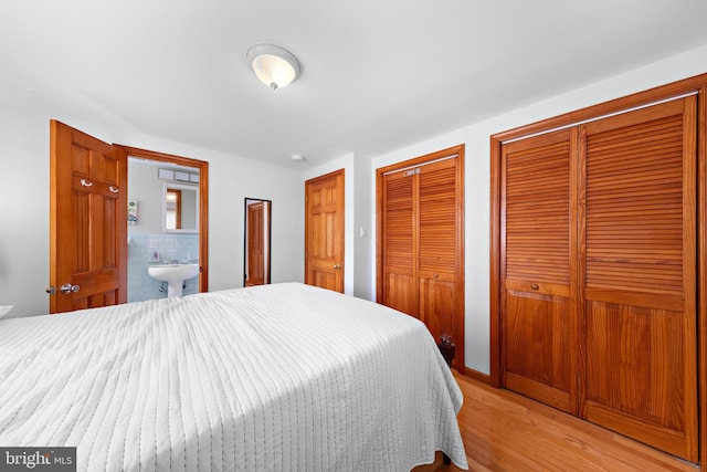 6203 Long Beach Blvd, Long Beach Township, NJ 08008 - bedroom with multiple closets, light wood finished floors, and connected bathroom