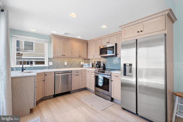 6203 Long Beach Blvd, Long Beach Township, NJ 08008 - kitchen with stainless steel appliances, light brown cabinets, light countertops, tasteful backsplash, and light wood-type flooring