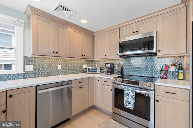 6203 Long Beach Blvd, Long Beach Township, NJ 08008 - kitchen featuring appliances with stainless steel finishes, light brown cabinets, light countertops, and recessed lighting
