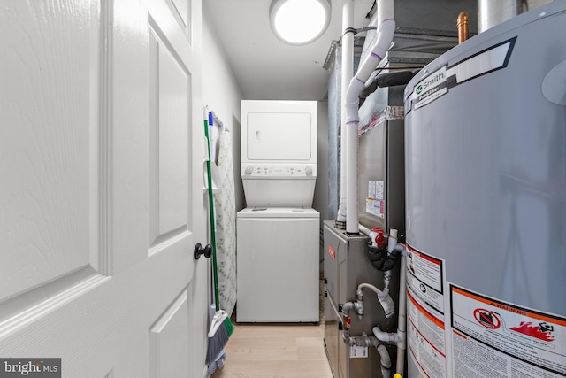 6203 Long Beach Blvd, Long Beach Township, NJ 08008 - laundry area featuring stacked washer / dryer, gas water heater, and light wood-type flooring