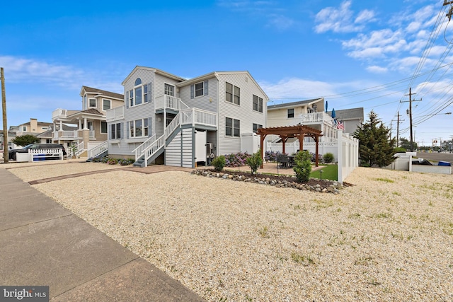6203 Long Beach Blvd, Long Beach Township, NJ 08008 - view of front of property with a pergola, a patio, and stairway