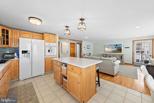 6203 Long Beach Blvd, Long Beach Township, NJ 08008 - kitchen with white appliances, light countertops, light tile patterned floors, glass insert cabinets, and a center island