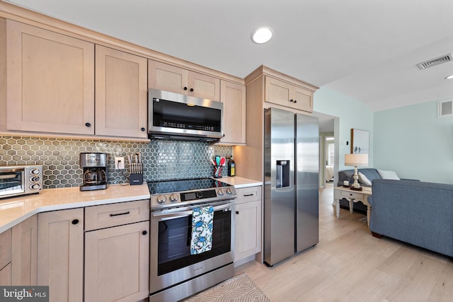 6203 Long Beach Blvd, Long Beach Township, NJ 08008 - kitchen with stainless steel appliances, light brown cabinetry, light wood-style floors, light countertops, and open floor plan