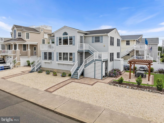 6203 Long Beach Blvd, Long Beach Township, NJ 08008 - view of front facade with stairway, a residential view, a pergola, and a patio area