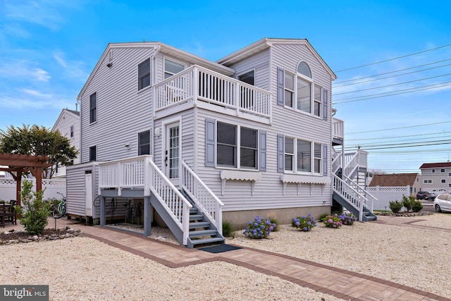 6203 Long Beach Blvd, Long Beach Township, NJ 08008 - rear view of house featuring a balcony and stairs