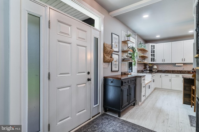 15065 Rock Point Rd, Newburg, MD 20664 - kitchen featuring white cabinets, decorative backsplash, light wood-style floors, open shelves, and glass insert cabinets