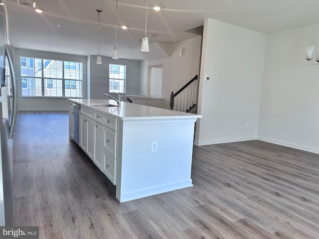 315 Allison Jane Dr Unit G20, Stevensville, MD 21666 - kitchen with open floor plan, appliances with stainless steel finishes, wood finished floors, a center island with sink, and light countertops