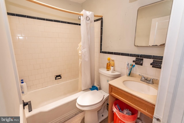 1536 Elrino St, Baltimore, MD 21224 - full bathroom featuring shower / bathtub combination with curtain, vanity, tile walls, and a wainscoted wall