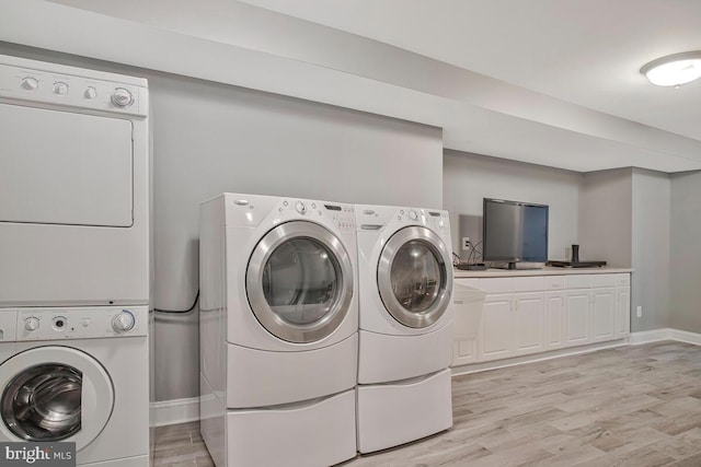 1506 White Tail Deer Ct, Annapolis, MD 21409 - laundry room featuring separate washer and dryer, light wood-style floors, and cabinet space