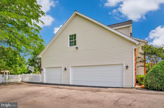 1506 White Tail Deer Ct, Annapolis, MD 21409 - view of side of property with a garage and asphalt driveway