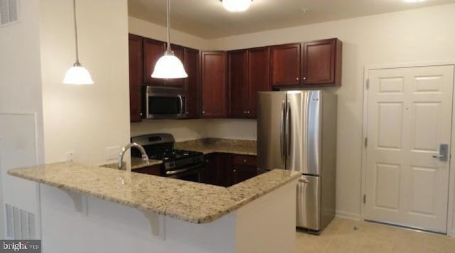 350 W Elm St Unit 3010, Conshohocken, PA 19428 - kitchen with stainless steel appliances, a peninsula, light stone counters, hanging light fixtures, and light tile patterned flooring