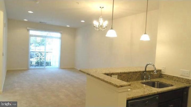 350 W Elm St Unit 3010, Conshohocken, PA 19428 - kitchen with dishwashing machine, light stone counters, a chandelier, pendant lighting, and light colored carpet
