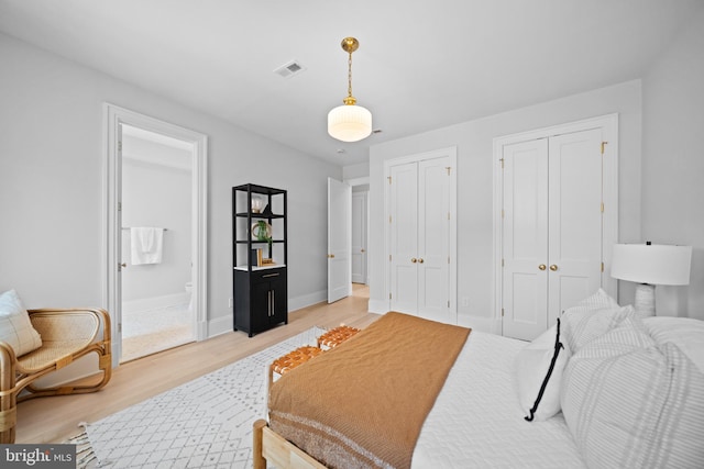 1834 16th St NW, Washington, DC 20009 - bedroom with multiple closets, light wood-style flooring, and connected bathroom