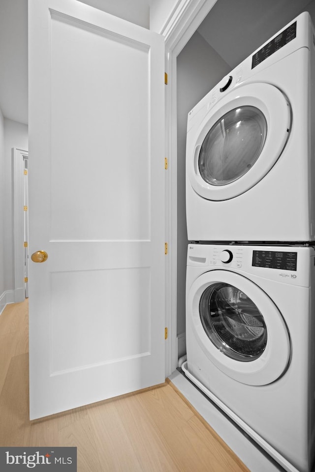 1834 16th St NW, Washington, DC 20009 - washroom featuring stacked washer and clothes dryer and wood finished floors