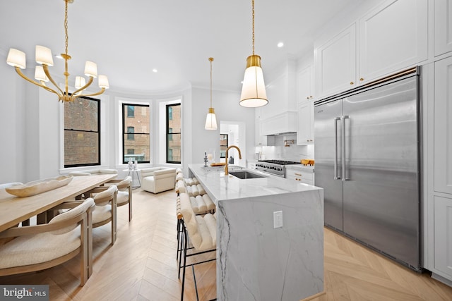 1834 16th St NW, Washington, DC 20009 - kitchen featuring premium appliances, a chandelier, light stone counters, ornamental molding, and recessed lighting