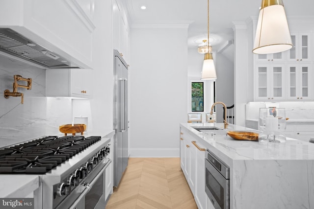 1834 16th St NW, Washington, DC 20009 - kitchen with built in appliances, white cabinetry, a center island with sink, crown molding, and recessed lighting
