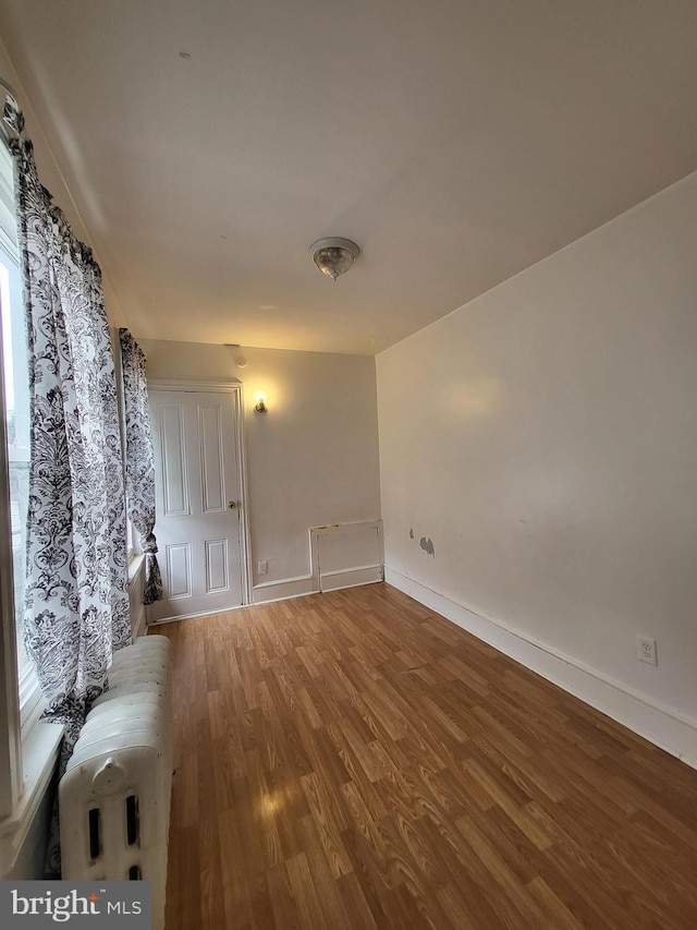 1116 Church St, Reading, PA 19601 - spare room featuring wood finished floors and radiator heating unit