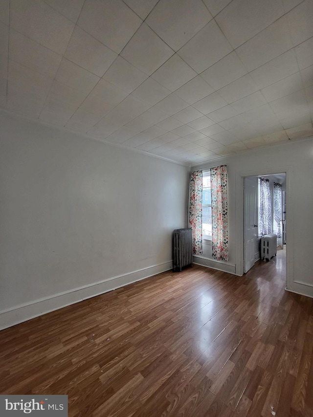 1116 Church St, Reading, PA 19601 - empty room featuring radiator heating unit and dark wood finished floors