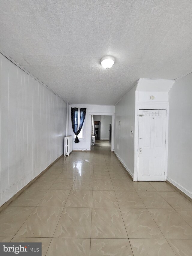 1116 Church St, Reading, PA 19601 - spare room featuring radiator heating unit and a textured ceiling