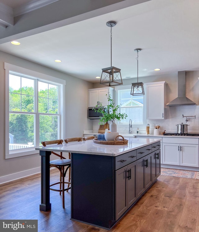 23 Old, Banks, Fredericksburg, VA 22406 - kitchen featuring wall chimney exhaust hood, a kitchen island, stainless steel appliances, light wood-style flooring, and recessed lighting
