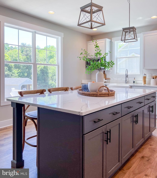 23 Old, Banks, Fredericksburg, VA 22406 - kitchen with gray cabinetry, a kitchen island, recessed lighting, light wood-style flooring, and a breakfast bar