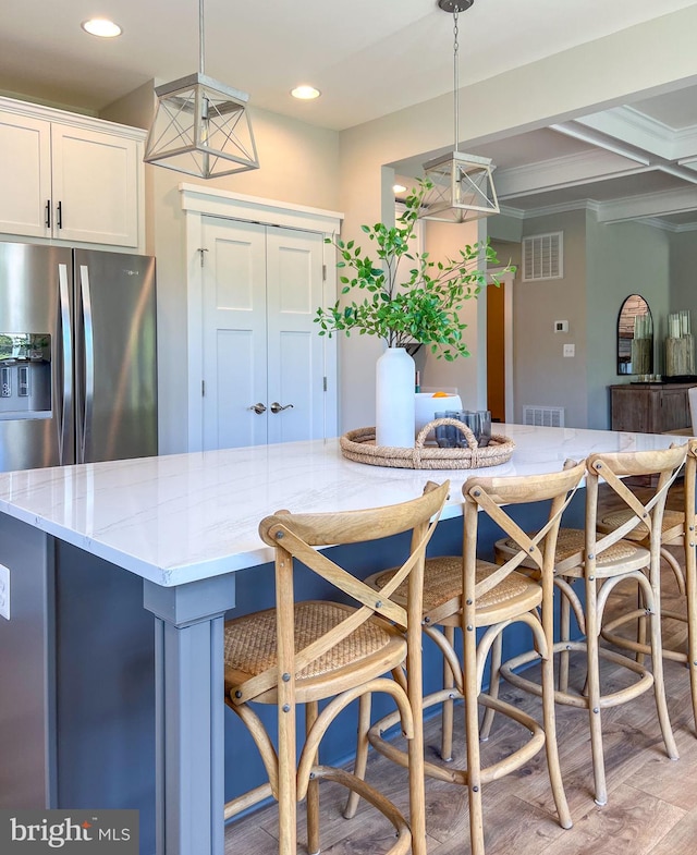 23 Old, Banks, Fredericksburg, VA 22406 - kitchen featuring light stone counters, hanging light fixtures, white cabinets, a breakfast bar area, and recessed lighting