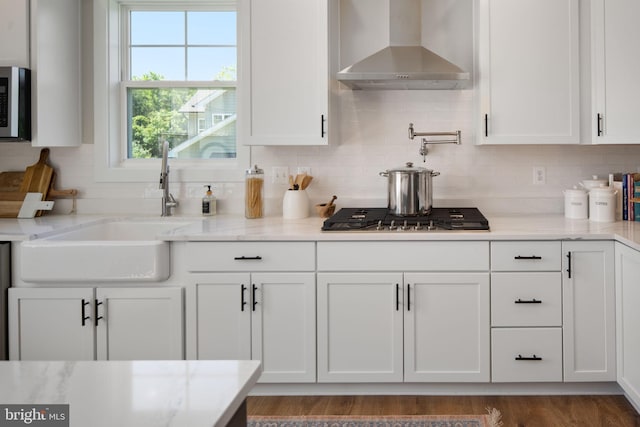 23 Old, Banks, Fredericksburg, VA 22406 - kitchen with wall chimney range hood, white cabinetry, stainless steel appliances, backsplash, and light stone counters