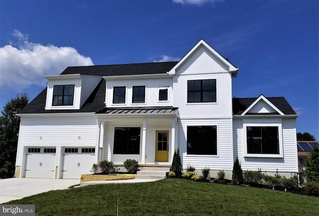 20 Monet Dr, Mays Landing, NJ 08330 - modern farmhouse with concrete driveway, a front yard, an attached garage, roof with shingles, and a standing seam roof