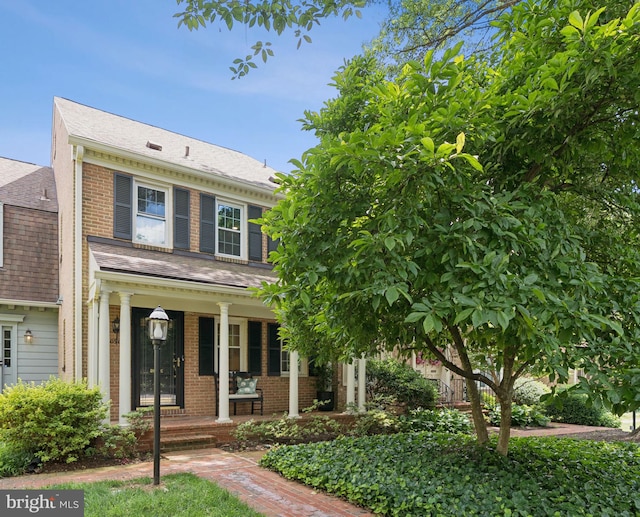10905 Wickshire Way Unit G-2, North Bethesda, MD 20852 - view of front facade featuring covered porch, brick siding, and a shingled roof