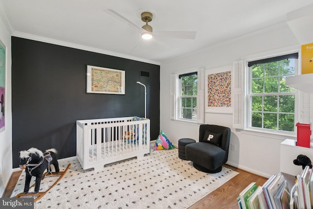 10905 Wickshire Way Unit G-2, North Bethesda, MD 20852 - bedroom with crown molding, wood finished floors, a crib, and ceiling fan