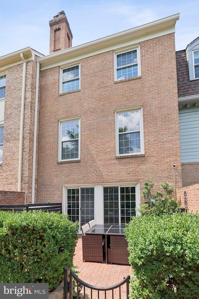 10905 Wickshire Way Unit G-2, North Bethesda, MD 20852 - rear view of property with a chimney and brick siding